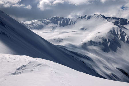 Snowy alpine landscape with blue sky. Caucasus Mountains, Georgia, region Gudauri.