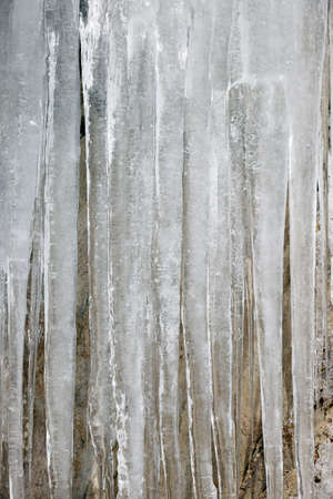 Icicles on the wall in winter. Close-up.の写真素材