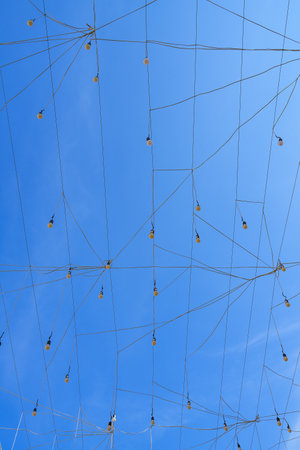 Abstract background of a blue sky with white clouds and wire net.の写真素材
