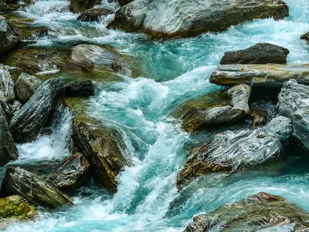 beautiful blue river flow through stone