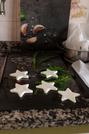 A black countertop with a star-shaped cookie tray. Graphic resourcesの写真素材