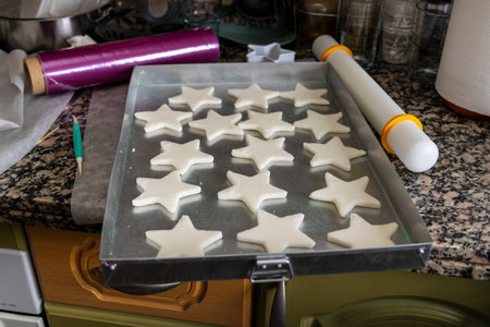 On a counter is a tray of cookies with stars.の写真素材