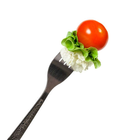 Vegetables on a fork on a white backgroundの写真素材