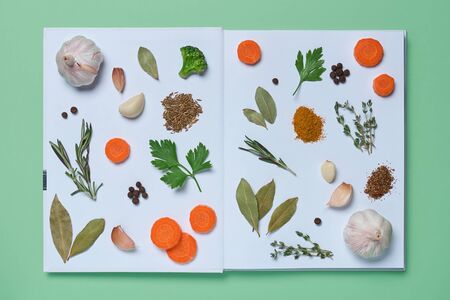 An open book of recipes with pictures of living vegetablesの写真素材