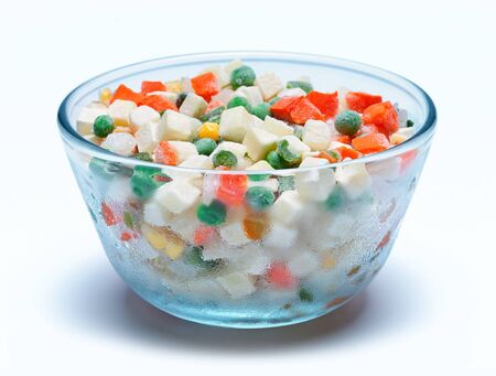 Glass bowl with frozen vegetables on a white backgroundの写真素材