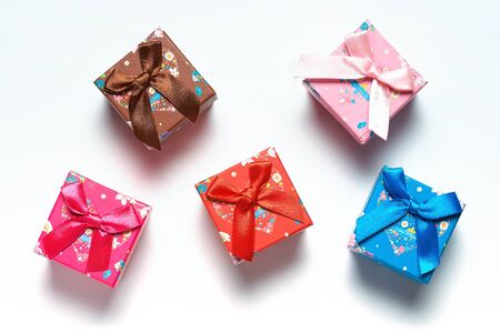 Small gift boxes scattered over white background