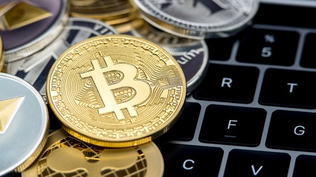 Physical metal golden Bitcoin currency on notebook computer keyboard. Worldwide virtual internet money. Digital coin cyberspace, cryptocurrency gold BTC. Good investment future online paymentの写真素材