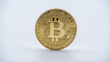 Physical metal golden Bitcoin currency on white background. New worldwide virtual internet money....