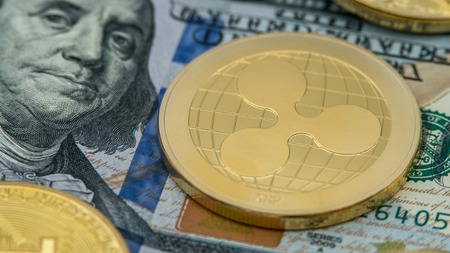 Physical metal golden Ripplecoin currency over diferents dollars bills of United States. Worldwide virtual internet money. USA banknotes. Digital gold Ripple coin cyberspace, cryptocurrency XRPの写真素材