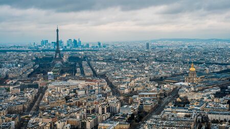 Aerial view of Eiffel Tower and Paris city. Elevated view of cityscape with tour Eiffel in cloudy and raining day of winter at France. Famous touristic places and popular travel destinationsの写真素材