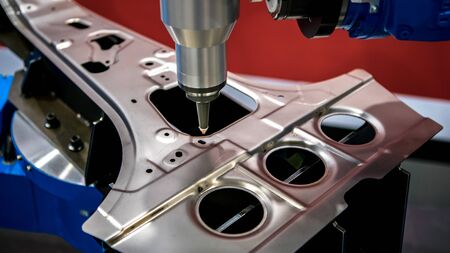 Robotic arms works on factory on manufacture of cars. Industrial robotic welders weld the car body....