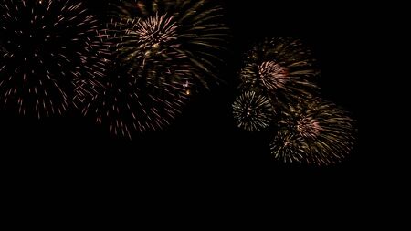 A beautiful Fireworks light up the sky with dazzling display on dark background. Celebration and anniversary concept. Firework show at night to celebrate the end of the holidays.の写真素材