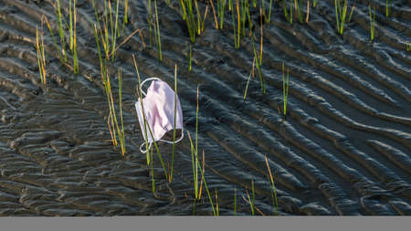 Coronavirus plastic waste polluting the environment. Disposable masks outbreak trash in the ocean....