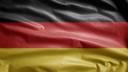 German flag waving in the wind. Close up of Germany banner blowing, soft and smooth silk. Cloth fabric texture ensign background. Use it for national day and country occasions concept.の写真素材