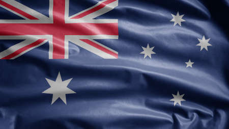 Australian flag waving in the wind. Close up of Australia banner blowing, soft and smooth silk. Cloth fabric texture ensign background. Use it for national day and country occasions concept.の写真素材