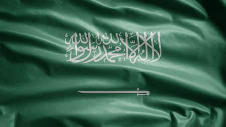 Kingdom Saudi Arabia flag waving in the wind. Close up of KSA banner blowing, soft and smooth silk. Cloth fabric texture ensign background. Use it for national day and country occasions concept.の写真素材