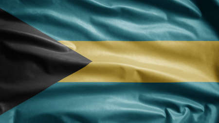 Bahamian flag waving in the wind. Close up of Bahamian banner blowing, soft and smooth silk. Cloth fabric texture ensign background. Use it for national day and country occasions concept.の写真素材