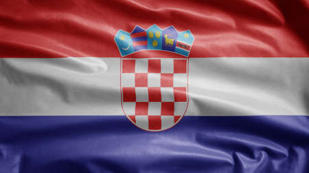 Croatian flag waving in the wind. Close up of Croatia banner blowing, soft and smooth silk. Cloth fabric texture ensign background. Use it for national day and country occasions concept.の写真素材