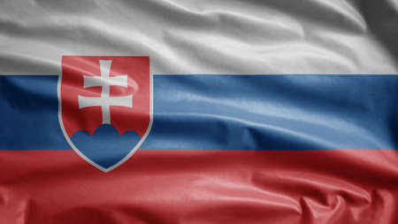 Slovak flag waving in the wind. Close up of Slovakia banner blowing, soft and smooth silk. Cloth fabric texture ensign background. Use it for national day and country occasions concept.の写真素材