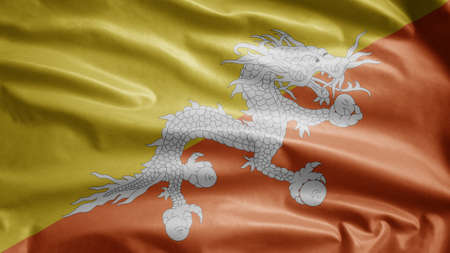 Bhutan flag waving in the wind. Close up of Butane banner blowing, soft and smooth silk. Cloth fabric texture ensign background. Use it for national day and country occasions concept.の写真素材