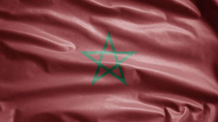Moroccan flag waving in the wind. Close up of Morocco banner blowing, soft and smooth silk. Cloth fabric texture ensign background.の写真素材