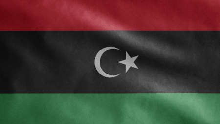 Libyan flag waving in the wind. Close up of Libya banner blowing, soft and smooth silk. Cloth fabric...