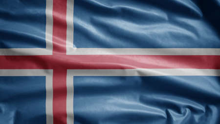 Icelandic flag waving in the wind. Close up of Iceland banner blowing, soft and smooth silk. Cloth fabric texture ensign background.の写真素材