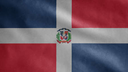 Dominican flag waving in the wind. Close up of Dominican Republic banner blowing, soft and smooth silk. Cloth fabric texture ensign background. Use it for national day and country occasions concept.の写真素材