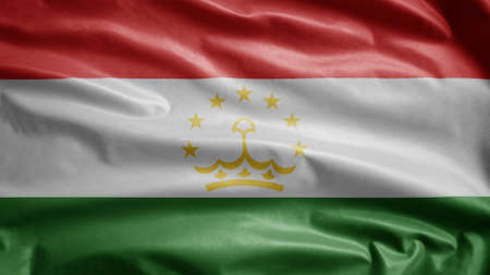 Tajikistani flag waving in the wind. Close up of Tajikistan banner blowing, soft and smooth silk. Cloth fabric texture ensign background. Use it for national day and country occasions concept.の写真素材