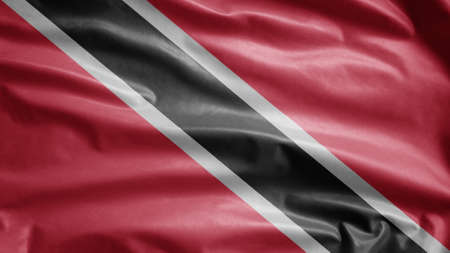 Trinidadian and Tobagonian flag waving in the wind. Close up of Trinidad and Tobago banner blowing, soft and smooth silk. Cloth fabric texture ensign backgroundの写真素材