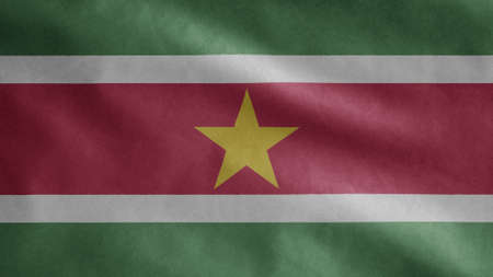 Surinamese flag waving in the wind. Close up of Suriname banner blowing, soft and smooth silk. Cloth fabric texture ensign background. Use it for national day and country occasions concept.の写真素材