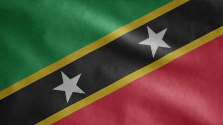 Saint Kitts and Nevis flag waving in the wind. Close up of Kittitian and Nevisian banner blowing, soft and smooth silk. Cloth fabric texture ensign backgroundの写真素材