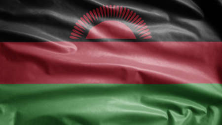 Malawian flag waving in the wind. Close up of Malawi banner blowing, soft and smooth silk. Cloth fabric texture ensign backgroundの写真素材