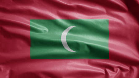 Maldivian flag waving in the wind. Close up of Maldives banner blowing, soft and smooth silk. Cloth fabric texture ensign background. Use it for national day and country occasions concept.の写真素材
