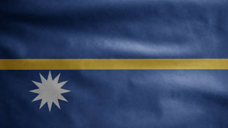 Nauruan flag waving in the wind. Close up of Nauru banner blowing, soft and smooth silk. Cloth fabric texture ensign background. Use it for national day and country occasions concept.の写真素材