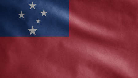 Samoan flag waving in the wind. Close up of Samoa banner blowing, soft and smooth silk. Cloth fabric texture ensign background.の写真素材