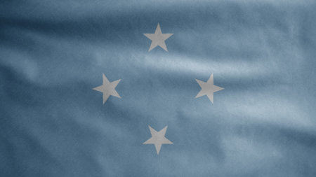 Micronesian flag waving in the wind. Close up of Micronesia banner blowing, soft and smooth silk. Cloth fabric texture ensign background. Use it for national day and country occasions concept.の写真素材