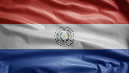 Paraguayan flag waving in the wind. Close up of Paraguay banner blowing, soft and smooth silk. Cloth fabric texture ensign background.の写真素材