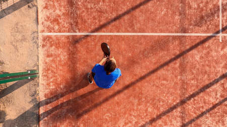 View from above of a padel player who is in his position waiting to hit the ball. Outdoor court.の写真素材