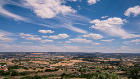 Aerial view of green fields under the sun of a beautiful spring morning. Scene of andalusia valley with large expanses of trees. Mountain rural landscape of Spain. Hills in community of Extremaduraの写真素材