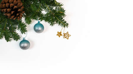 Frame of green pine branch with pinecone flower and Christmas balls on white background and space for text. Top view of fir tree branches and Xmas baubles for decoration banner and New Year concept.の写真素材