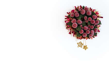 Beautiful holly leaf wreath with tinsel christmas and copy space for text. Xmas ribbon garland with traditional red berry decorations isolated on white backgroundの写真素材