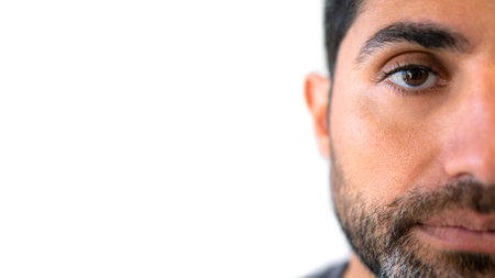 Headshot of serious male looks confidently at camera, thinking about question, pensive expression, dressed casually isolated over white backgroundの写真素材