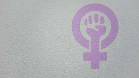 A drawing of strong fist raised up with woman gender with copy space aside for your promotional text or advertisement on white drip wall background. Feminism symbol conceptの写真素材