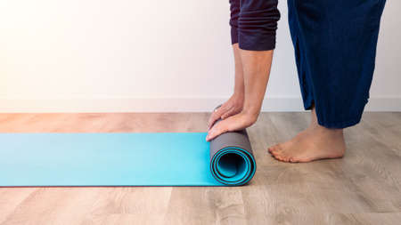 Elevate view male hands in sportswear doing yoga in the house indoor, healthy person meditation in...