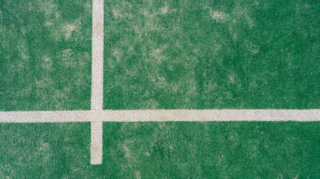 Top view of line on floor and part of green synthetic grass paddle tennis court indoor without people. Padel is a racquet game. Professional sport concept with copy space for textの写真素材