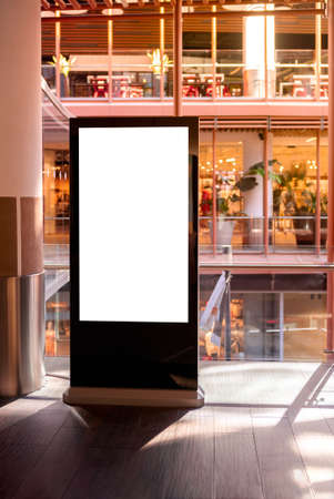 Vertical sign mockup of billboard advertisement in shopping mall. Mock up ready for your design preview. Mock-up with copy space for design presentation.の写真素材