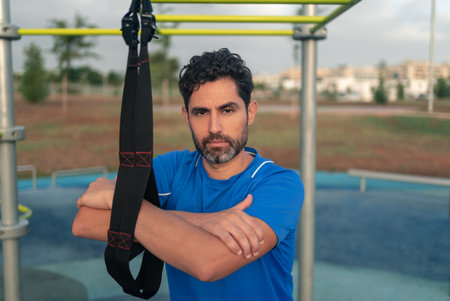 Portrait of confident caucasian man exercising outside in sunny park. Great workout. Young handsome...