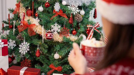 Adorned with holiday elements, a festive Christmas balls and snowflakes hang on the tree lush green...