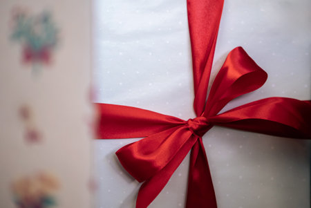 Under a modern Christmas tree, elegantly white wrapped gift boxes enhance the holiday ambiance in a home, alongside holiday Xmas ornaments, as a design element for New Year decor.の写真素材